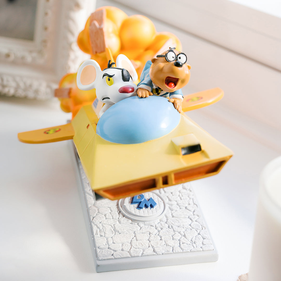 Close-up of Danger Mouse and Penfold figures on the Mark III statue, showing painted facial detail
