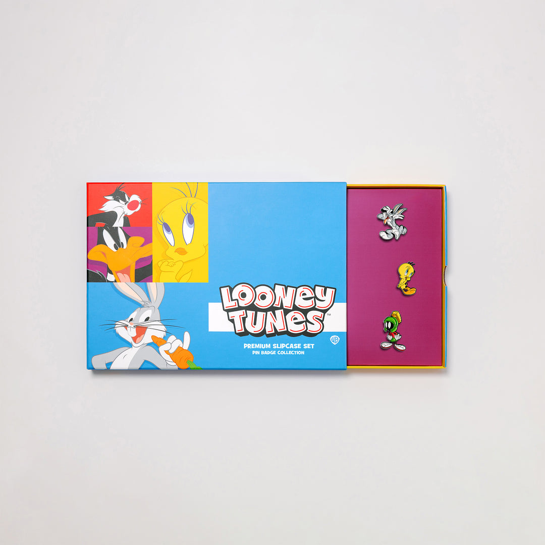 Looney Tunes pin badge box set with premium slipcase partially open showing enamel pins inside