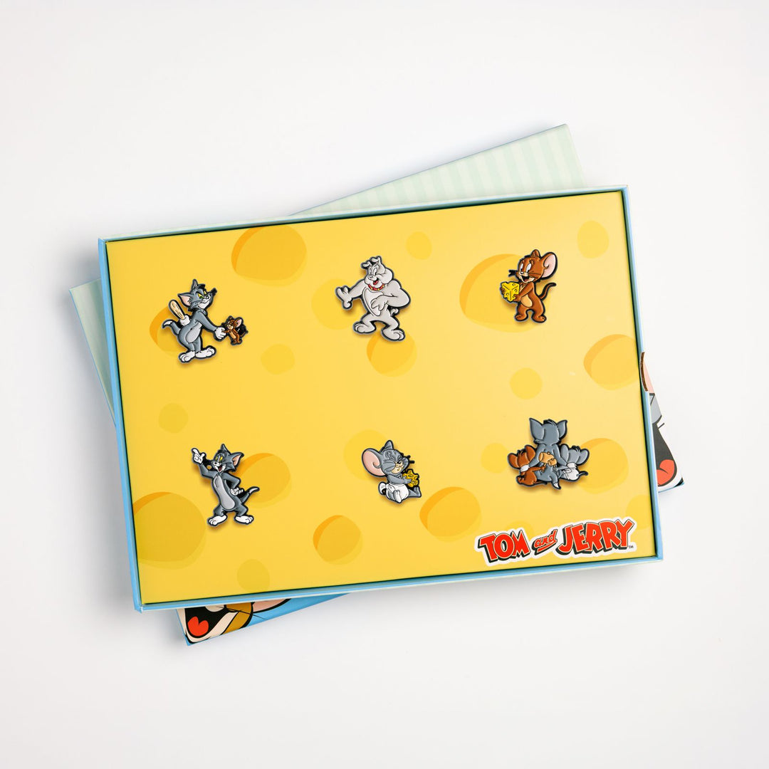 Open Tom and Jerry box set tray displaying all 6 enamel pin badges in insert